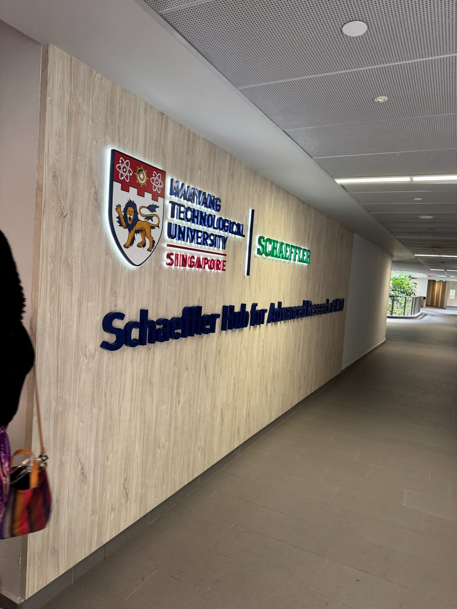 A wooden wall with the NTU Singapore and Schaeffler logos and the sign Schaeffler Hub for Advanced Research at NTU